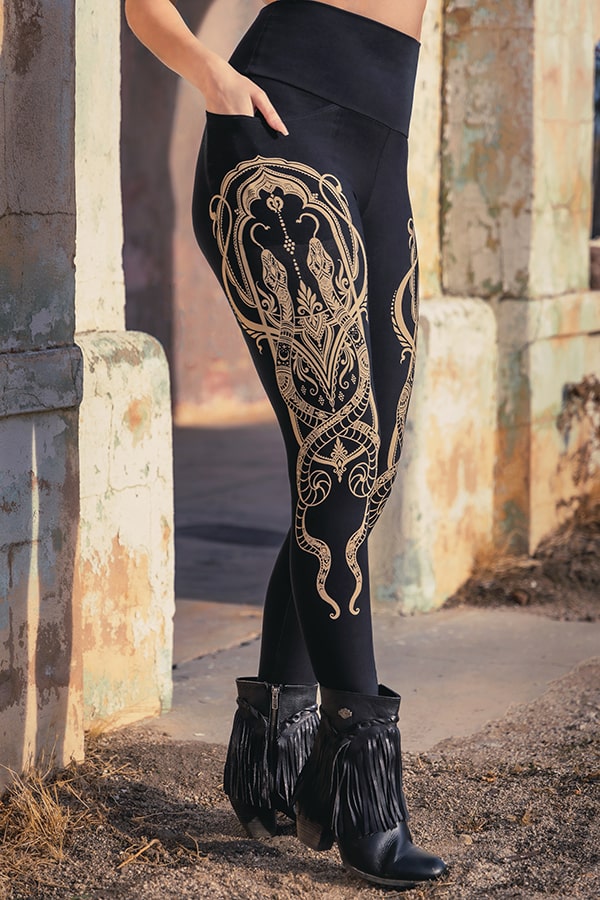 Close-up of Elsa Legging showing detailed Art Nouveau-inspired snake motif along the leg.

