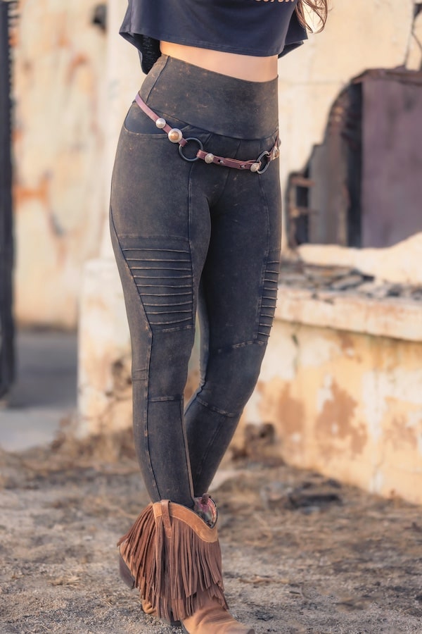 Rustique Moto Legging, modeled against boho building and earth textures, emphasizing color and texture.